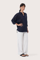 By The Sea Bali Side profile of the Faye Linen Shirt in Navy showcasing its relaxed fit