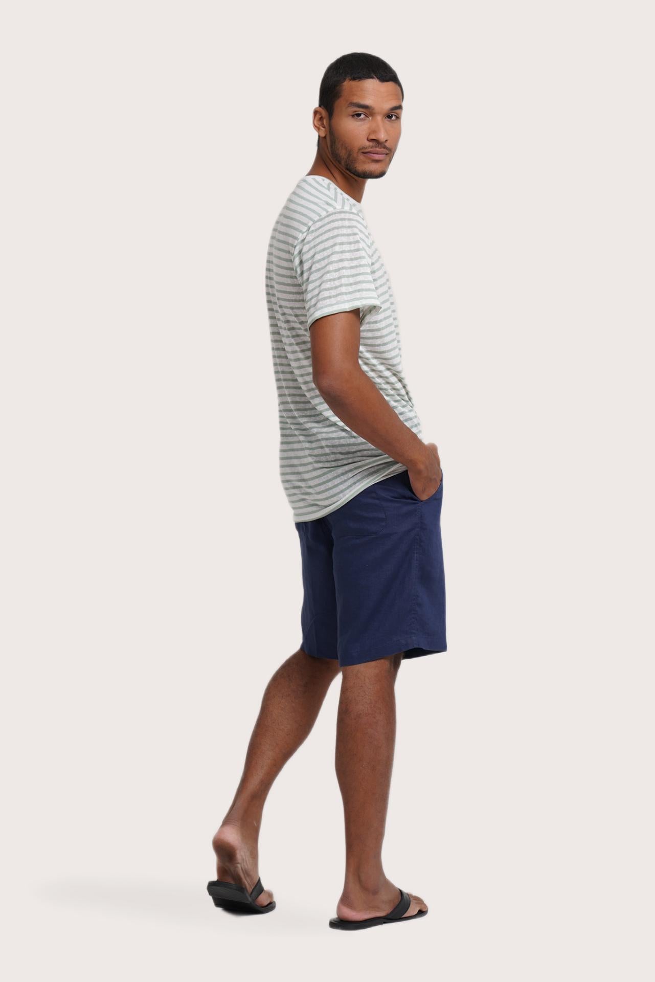 Side profile of the Geva T-shirt Stripe in Paste Green by By The Sea Bali – relaxed drape and understated island elegance