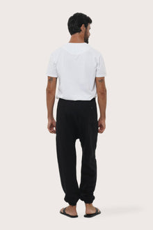 Back view of the black linen rayon loose pants with a relaxed and flowing silhouette
