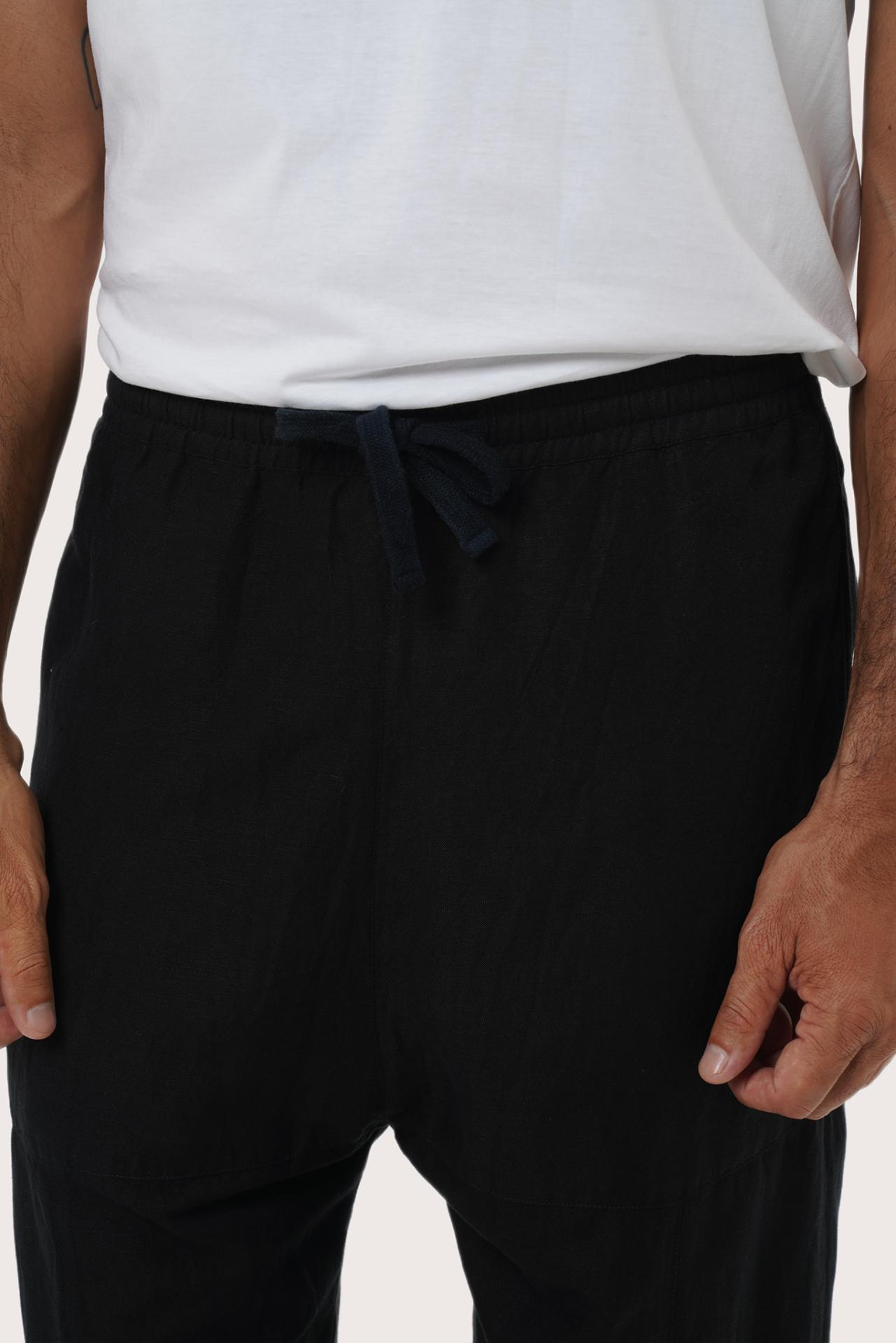 Close-up of the linen rayon fabric texture and tailored detailing on the black loose pants