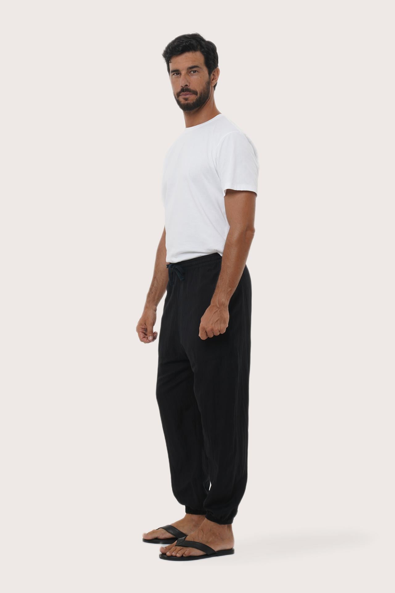 Side profile of the black linen rayon Goa loose pants showcasing their effortless drape