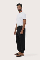 Side profile of the black linen rayon Goa loose pants showcasing their effortless drape