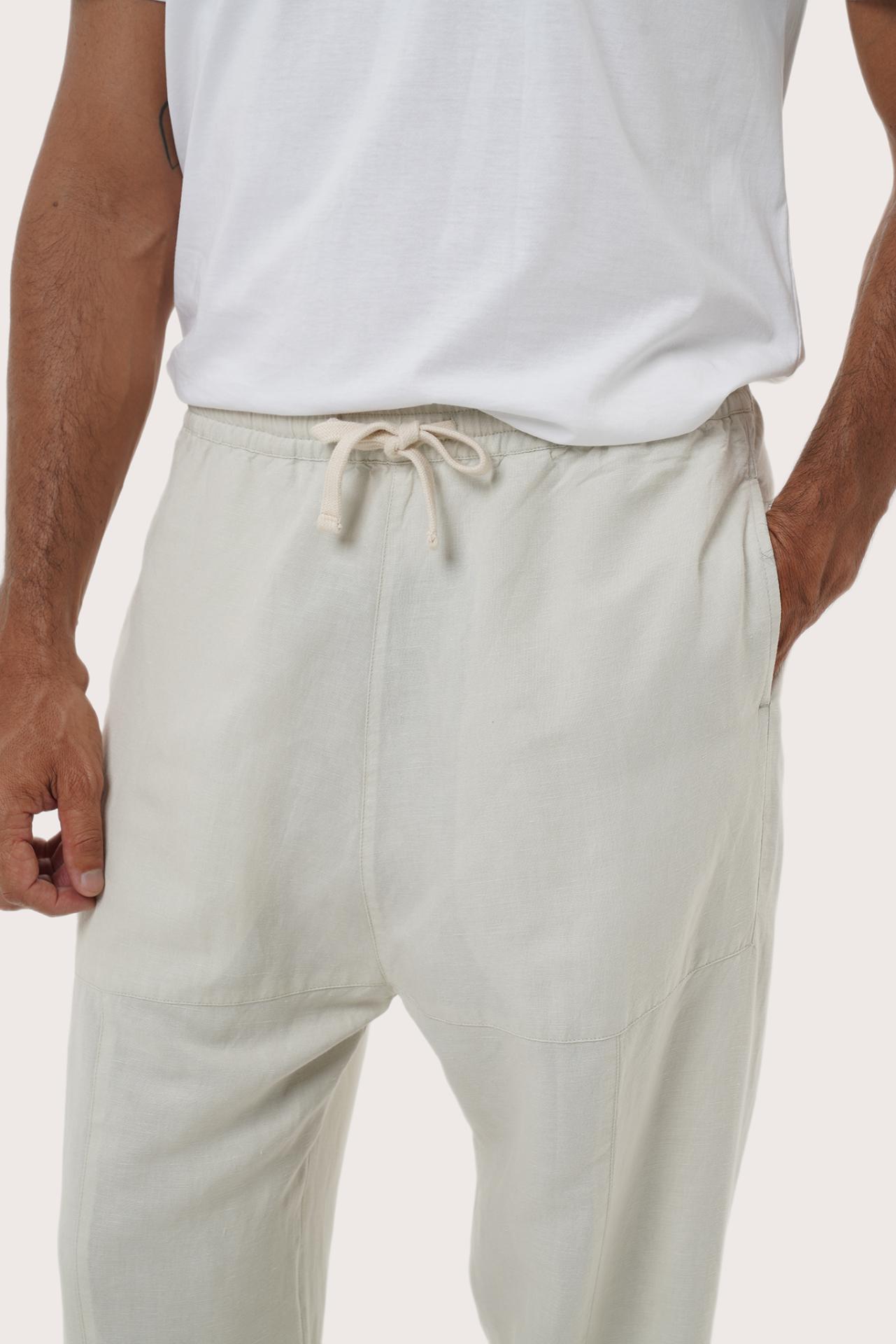 Close-up of the linen rayon fabric texture and tailored detailing on the ivory loose pants