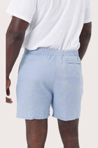 Detailed back view highlighting the relaxed silhouette and linen craftsmanship