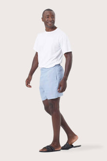 Side profile of the blue linen shorts showcasing their effortless fit