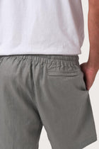 Detailed back view highlighting the relaxed silhouette and linen craftsmanship