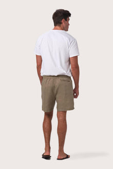 Detailed back view highlighting the relaxed silhouette and linen craftsmanship