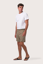 Side profile of the olive linen shorts showcasing their effortless fit