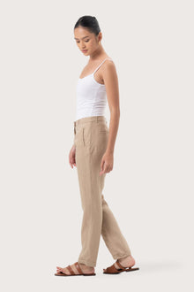 Side profile of the Hampton Women's Linen Pants Creme showing its cut and natural movement.