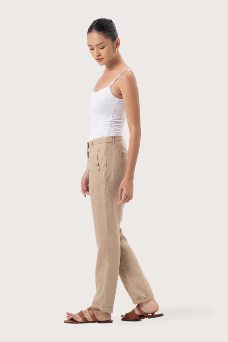Side profile of the Hampton Women's Linen Pants Creme showing its cut and natural movement.