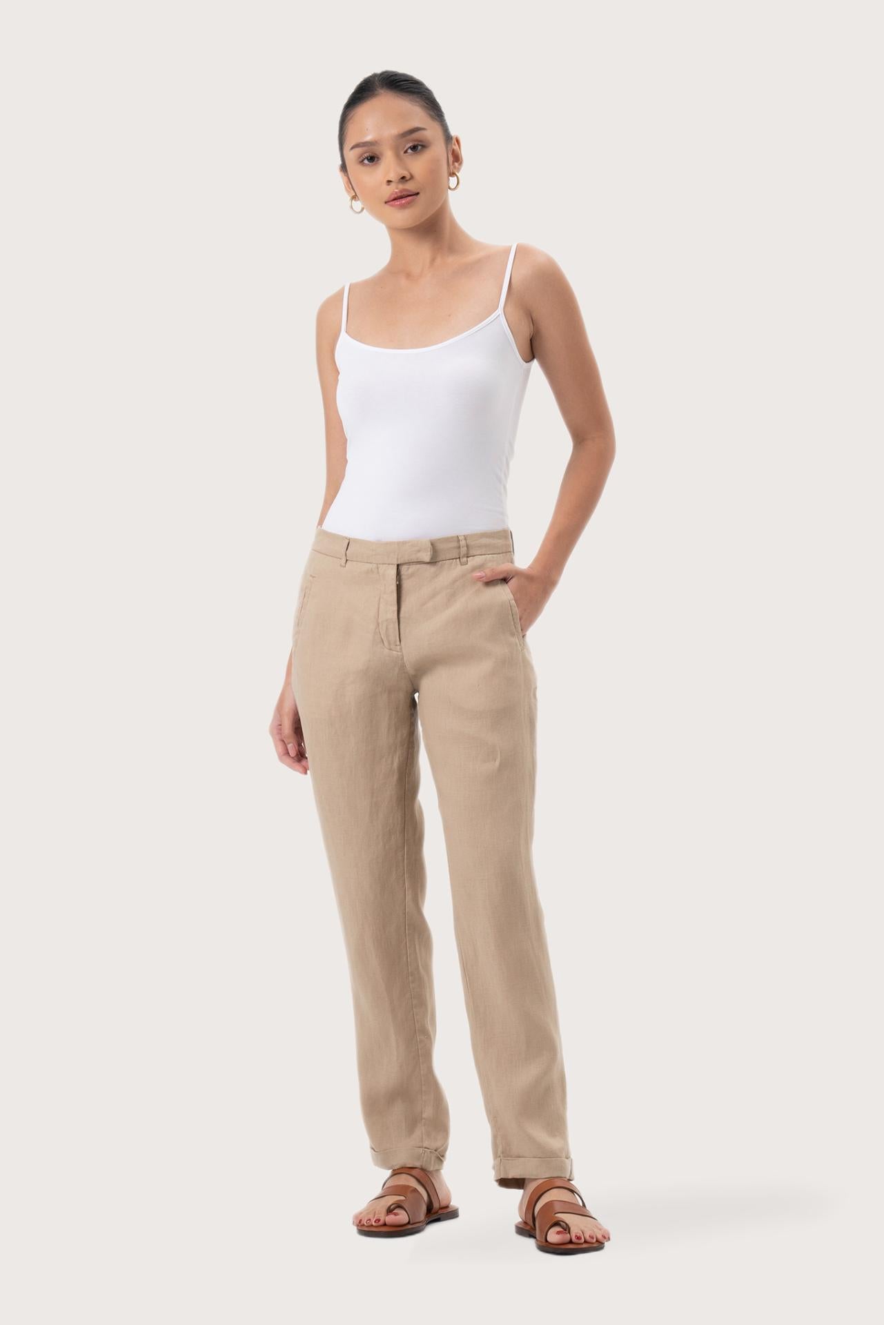 Woman wearing the Hampton Women's Linen Pants Creme designed for effortless resortwear and tropical living by By The Sea Bali.
