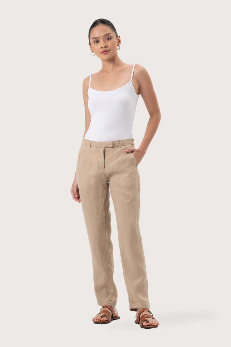 Woman wearing the Hampton Women's Linen Pants Creme designed for effortless resortwear and tropical living by By The Sea Bali.