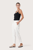 Side profile of the Hampton Women's Linen Pants Off White showing its cut and natural movement.