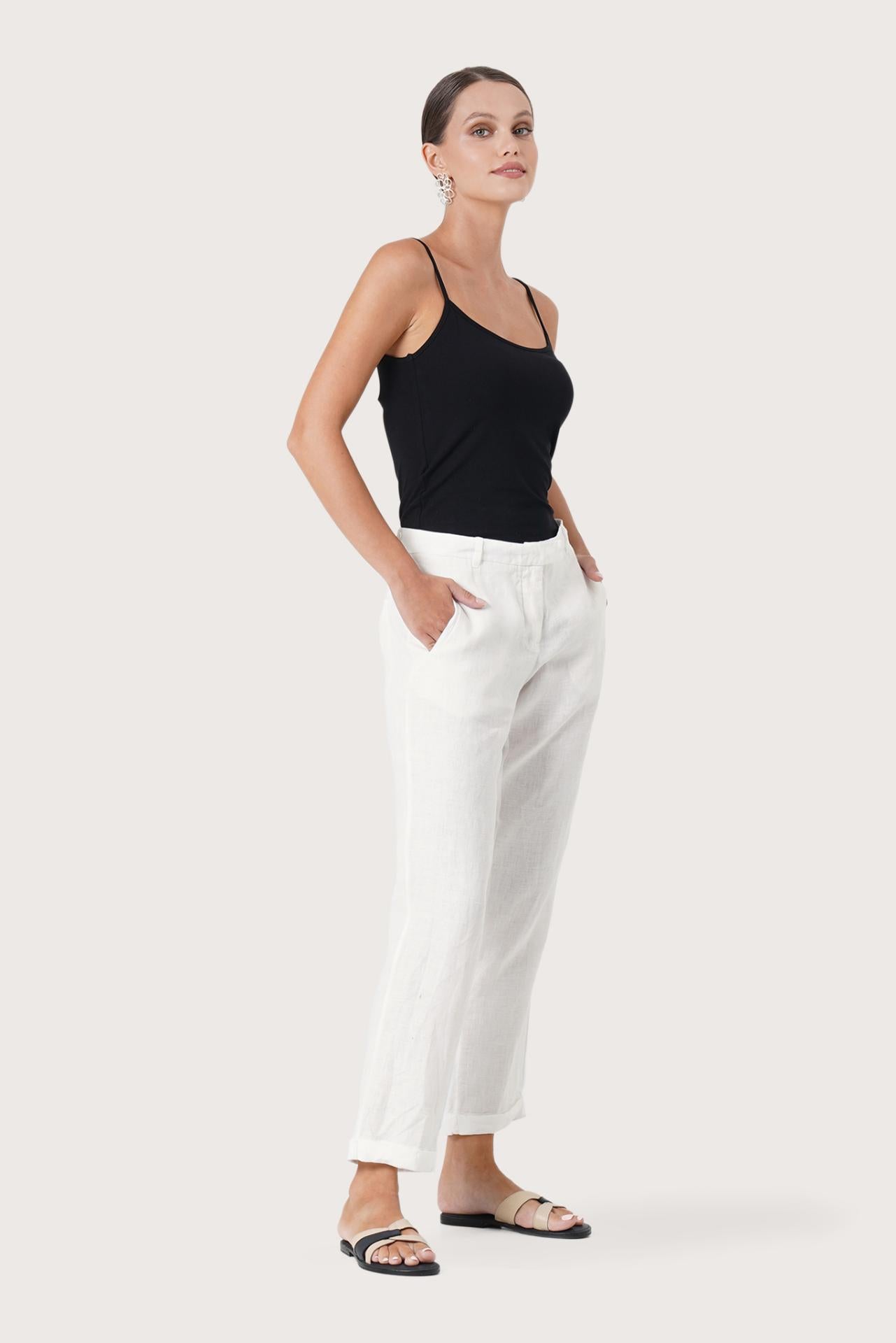Side profile of the Hampton Women's Linen Pants Off White showing its cut and natural movement.