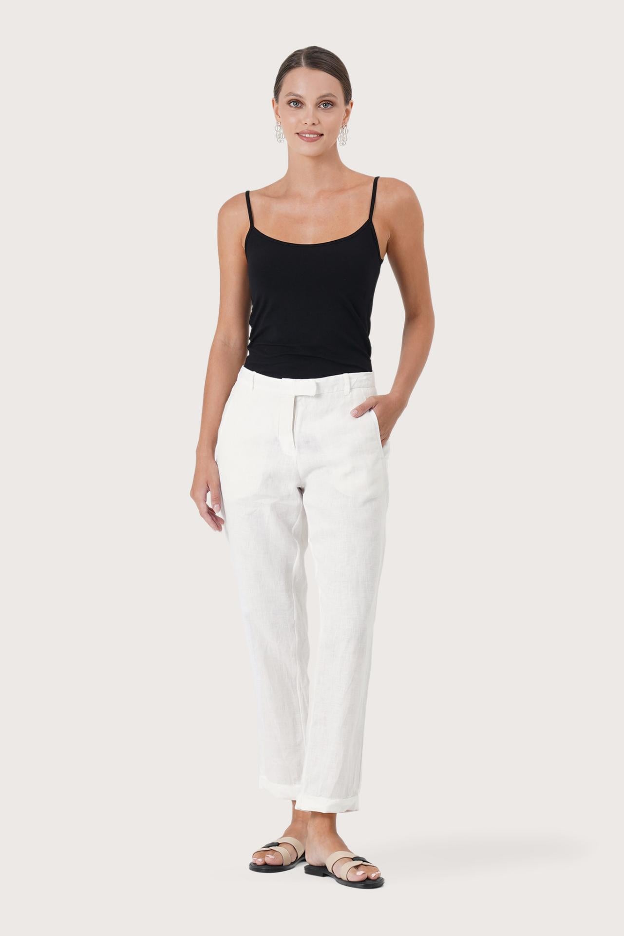 Woman wearing the Hampton Women's Linen Pants Off White designed for effortless resortwear and tropical living by By The Sea Bali.