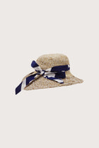Luxury resort styling featuring the Honolulu Straw Hat in a tropical coastal setting