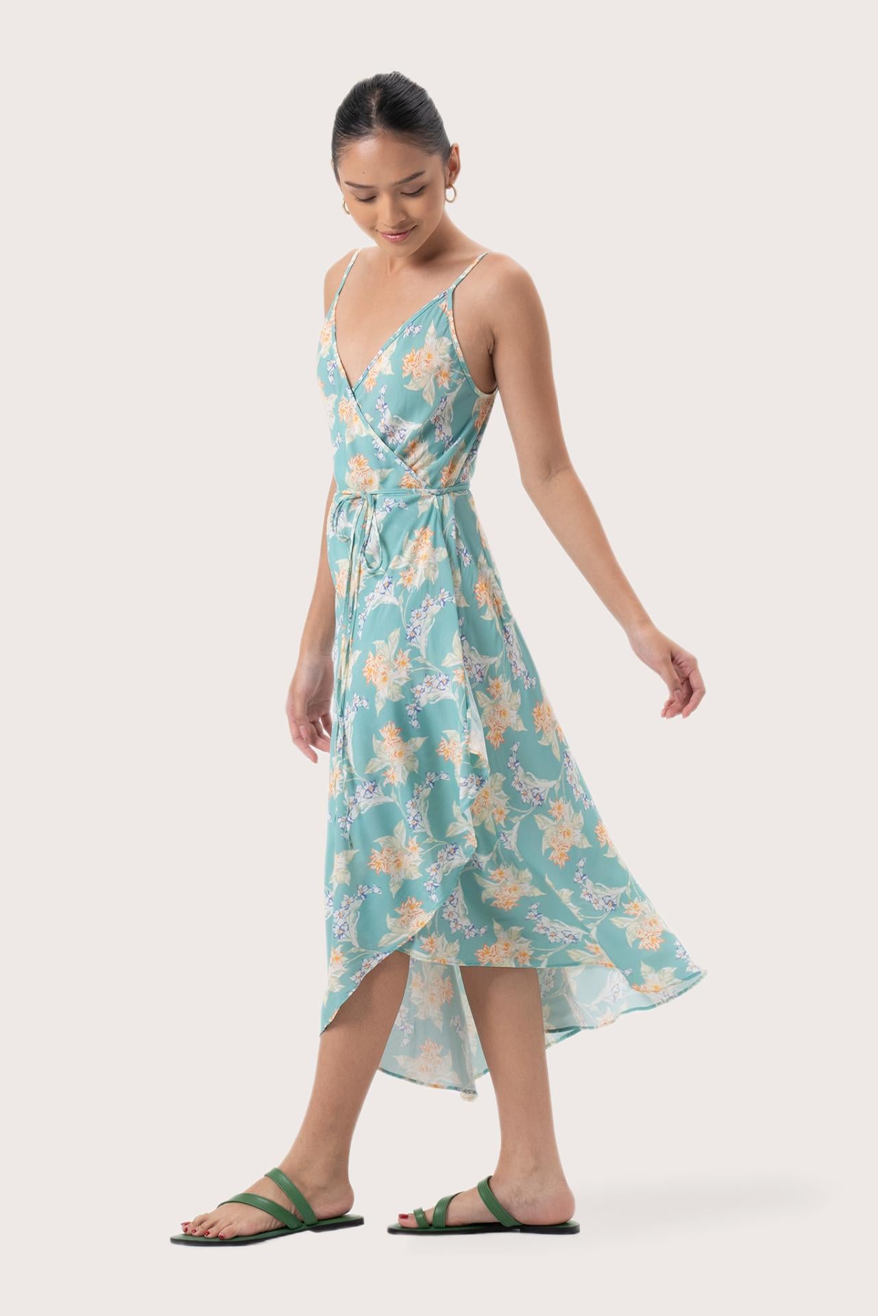 Side profile of the Ilona Wrapped Dress Tosca Green showing its cut and natural movement