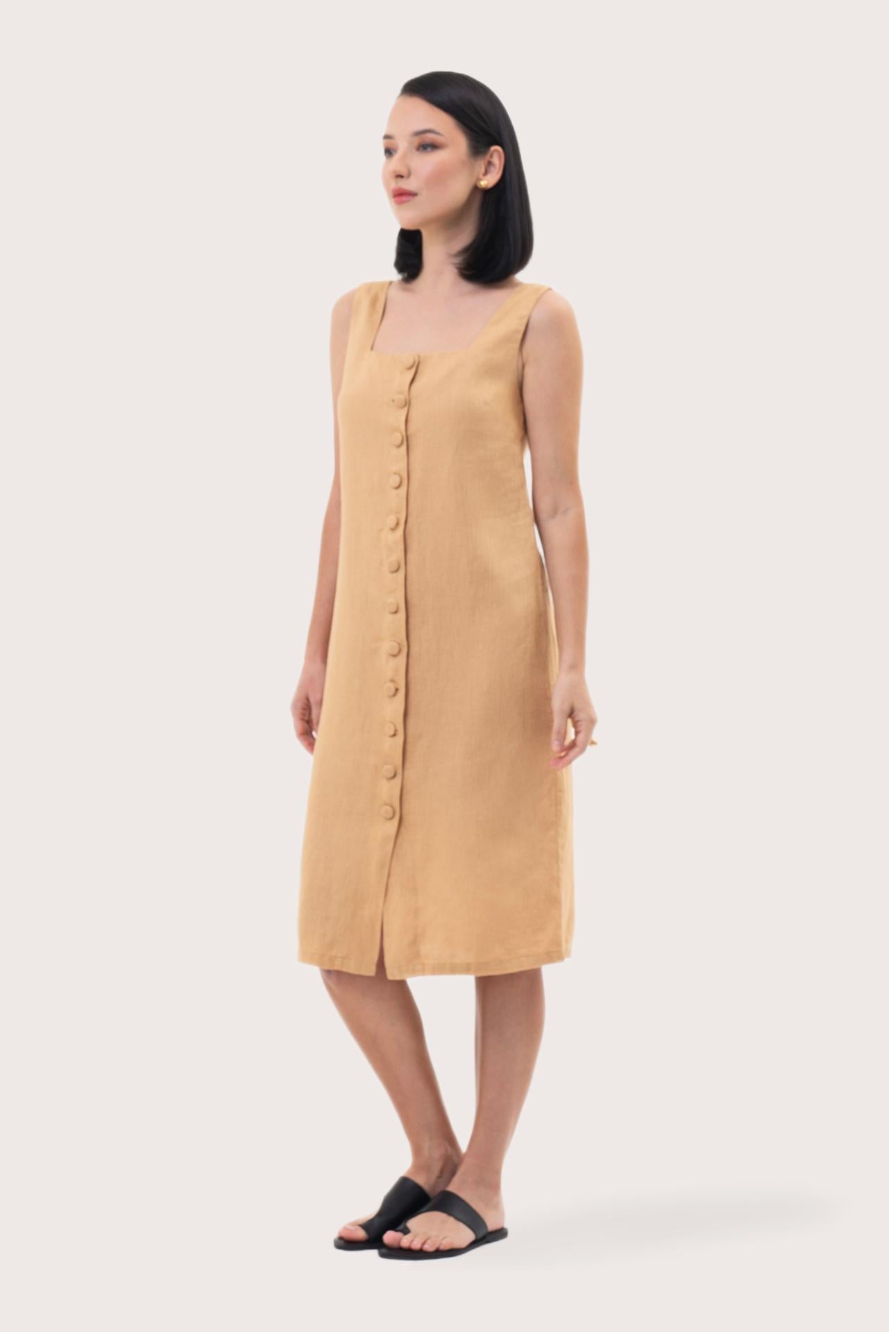 Side profile of the Linda Front Button Midi Linen Dress Pale Yellow showing its cut and natural movement