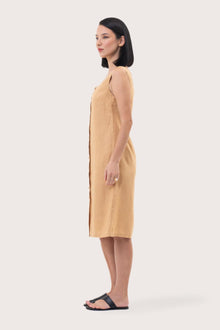 Side profile of the Linda Front Button Midi Linen Dress Pale Yellow showing its cut and natural movement