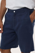 Close-up of the linen fabric texture and refined tailoring details on the La Brisa bermuda shorts