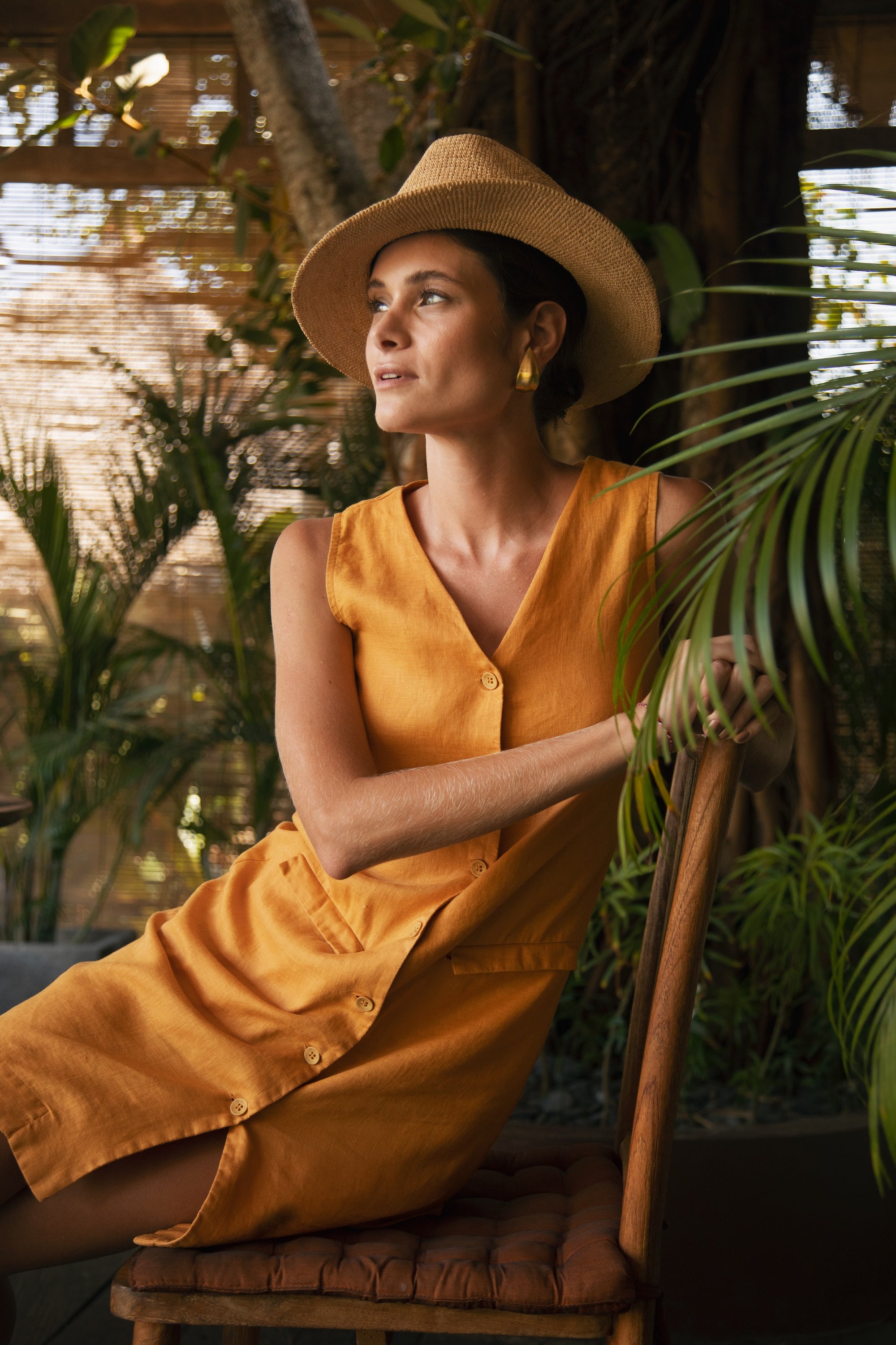 Woman wearing the Isla Linen Dress Orange designed for effortless resortwear and tropical living by By The Sea Bali