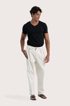 Side view of the creme Joey Pant showcasing its silhouette