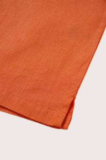 Refined resortwear styling in a vibrant Orange linen shade