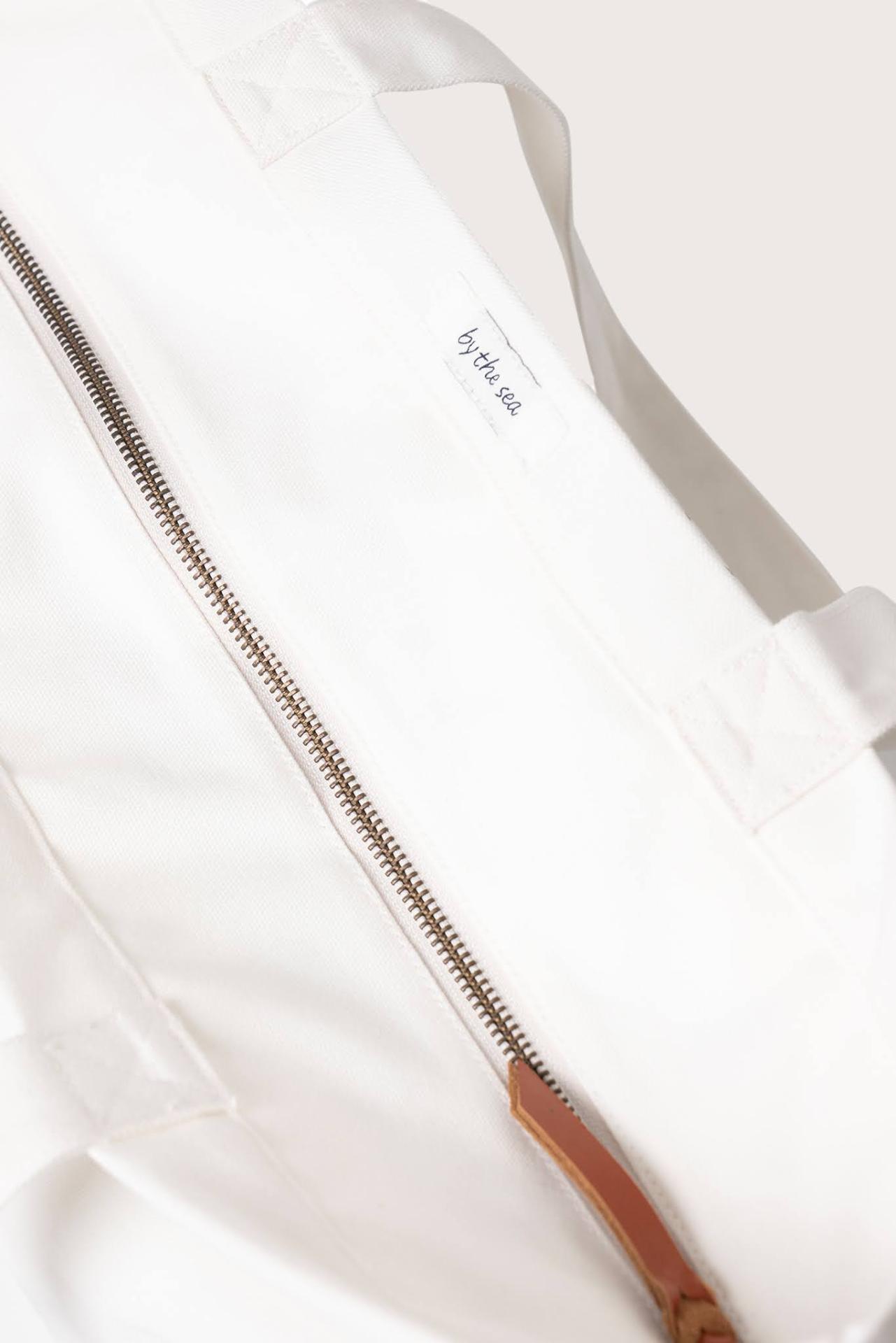 Angled view of the Kaia Bag White revealing its refined construction and elegant details