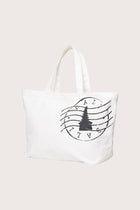 Kaia Bag White styled in a tropical resort setting with effortless coastal elegance