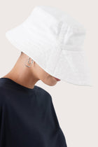 Side view of the Kalulla Cotton Hat Off White highlighting its soft cotton construction and relaxed shape