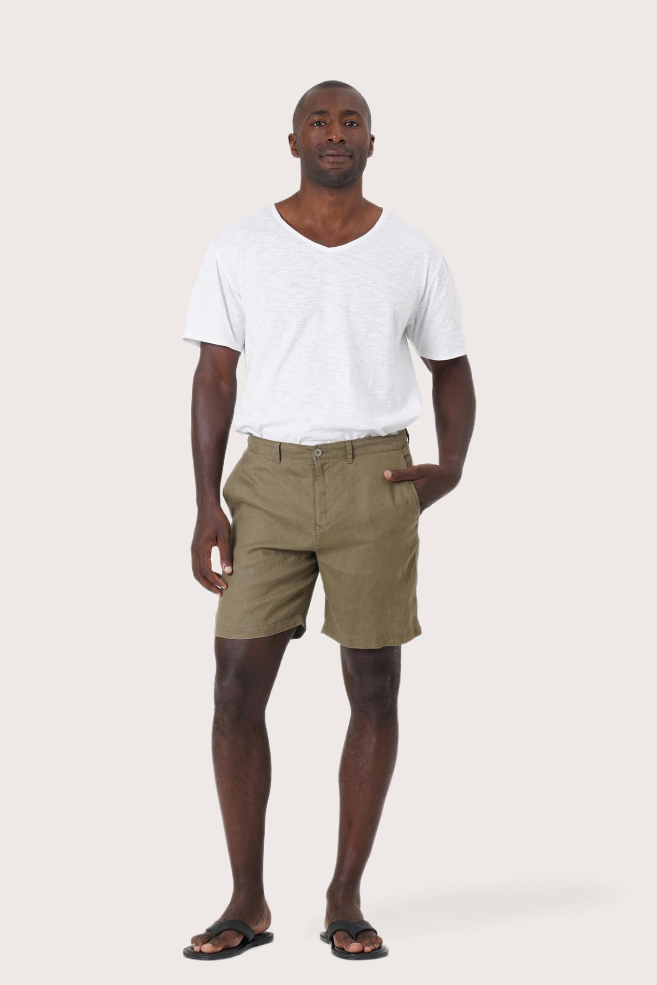 Model wearing the brown linen Kama bermuda shorts by By The Sea Bali