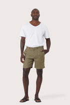 Model wearing the brown linen Kama bermuda shorts by By The Sea Bali