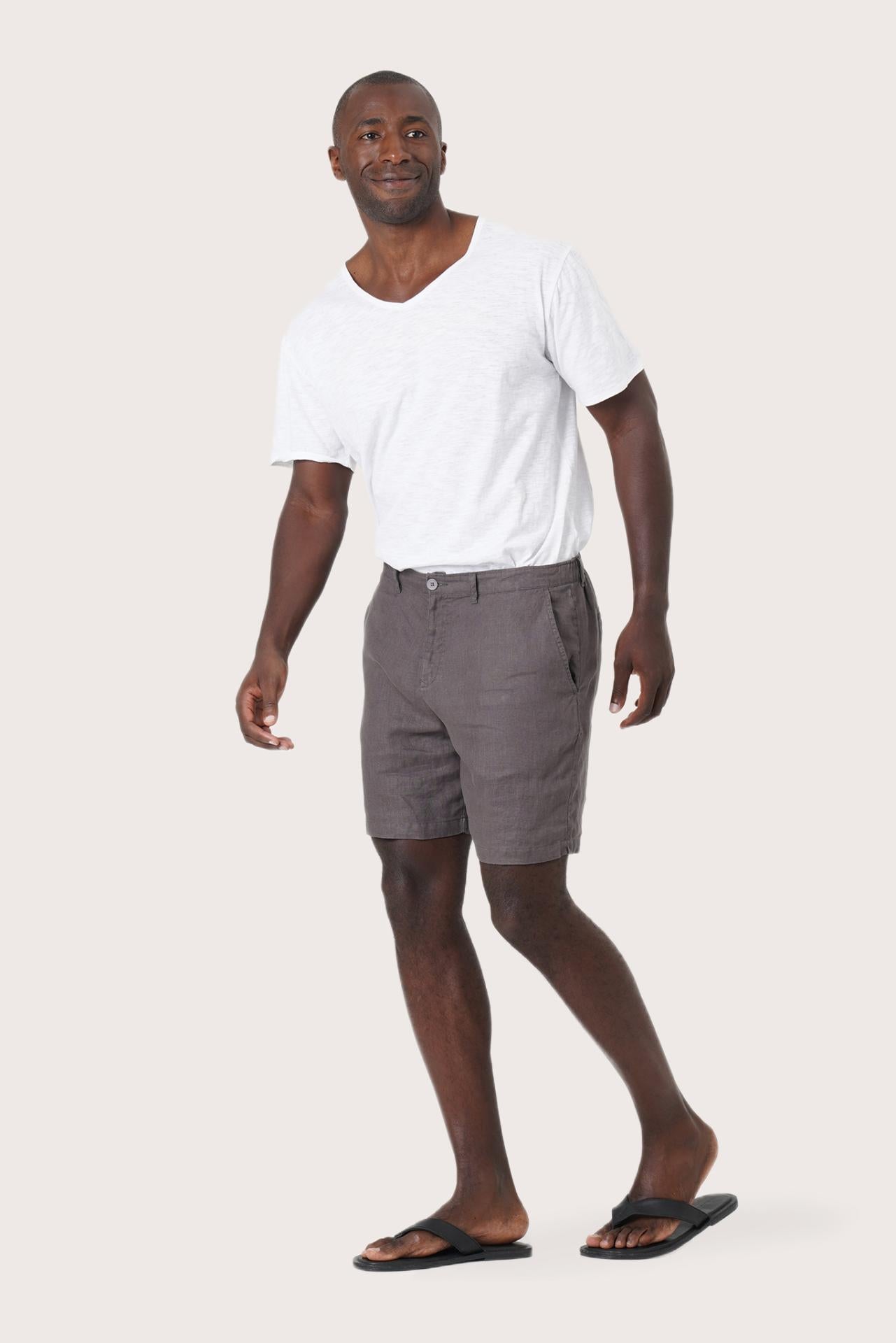 Side profile of the grey brown linen bermuda shorts showcasing their effortless fit