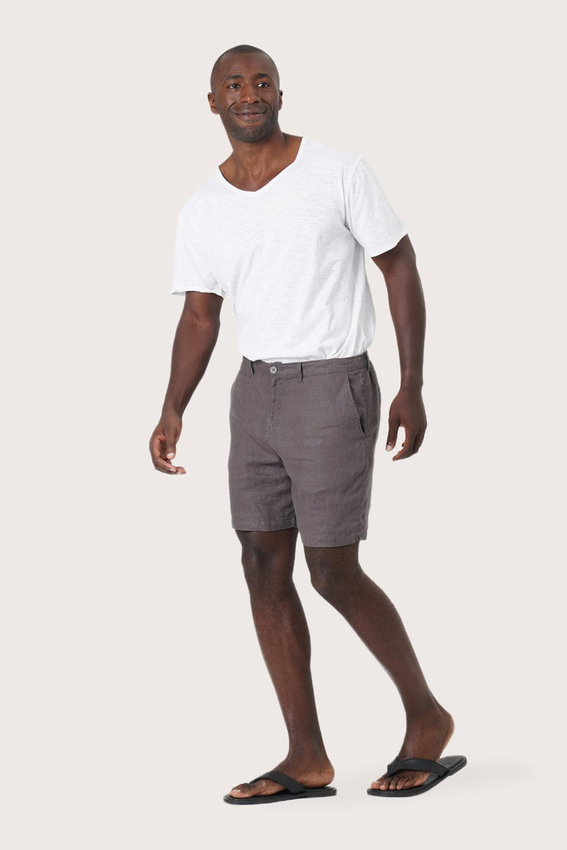 Side profile of the grey brown linen bermuda shorts showcasing their effortless fit