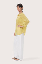 By The Sea Bali Side profile of the Kami Shirt showcasing its relaxed fit and fluid drape