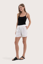 Lightweight linen bermuda shorts designed for refined tropical dressing