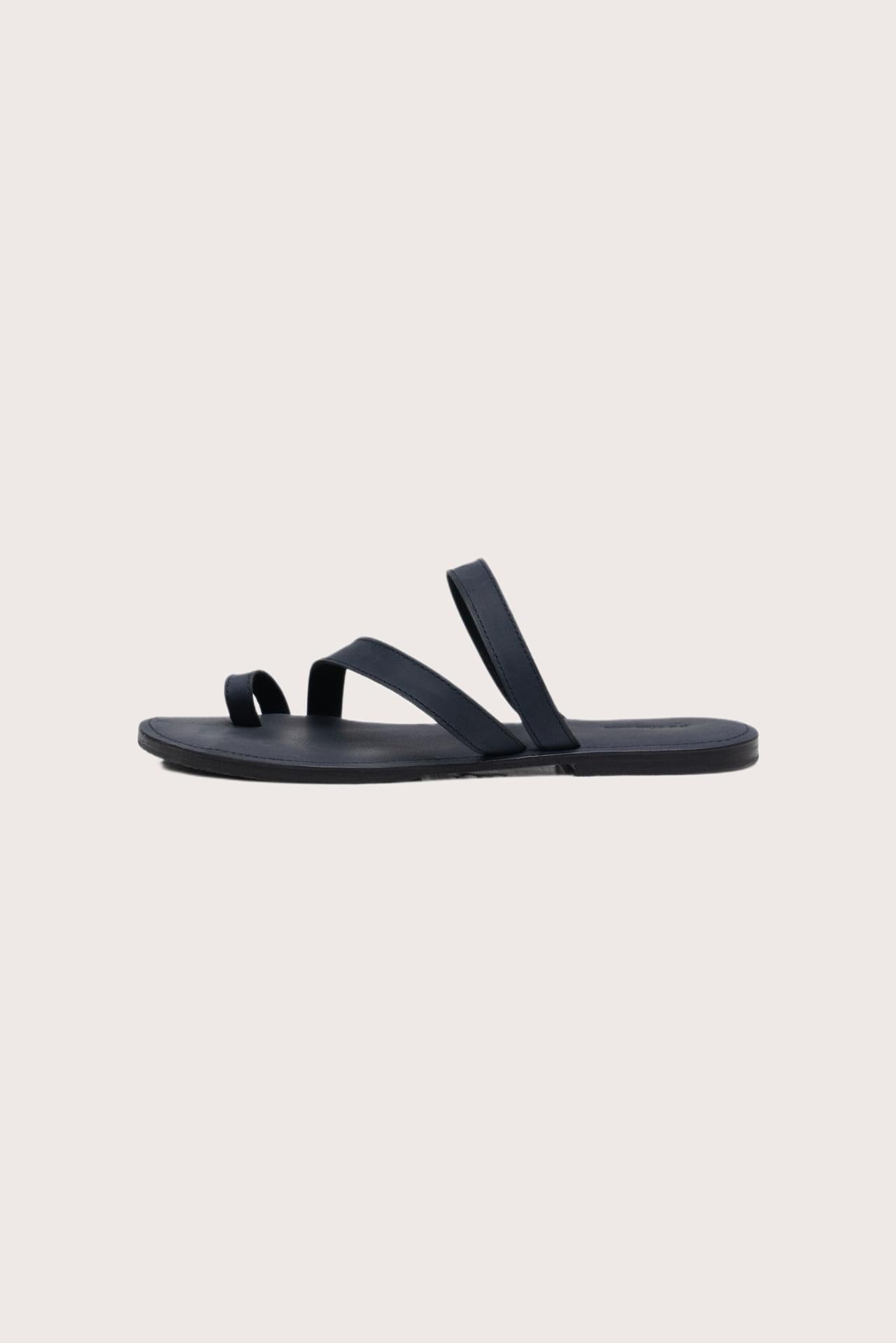 Side profile of Kawula sandal in navy highlighting sleek and modern resort footwear silhouette