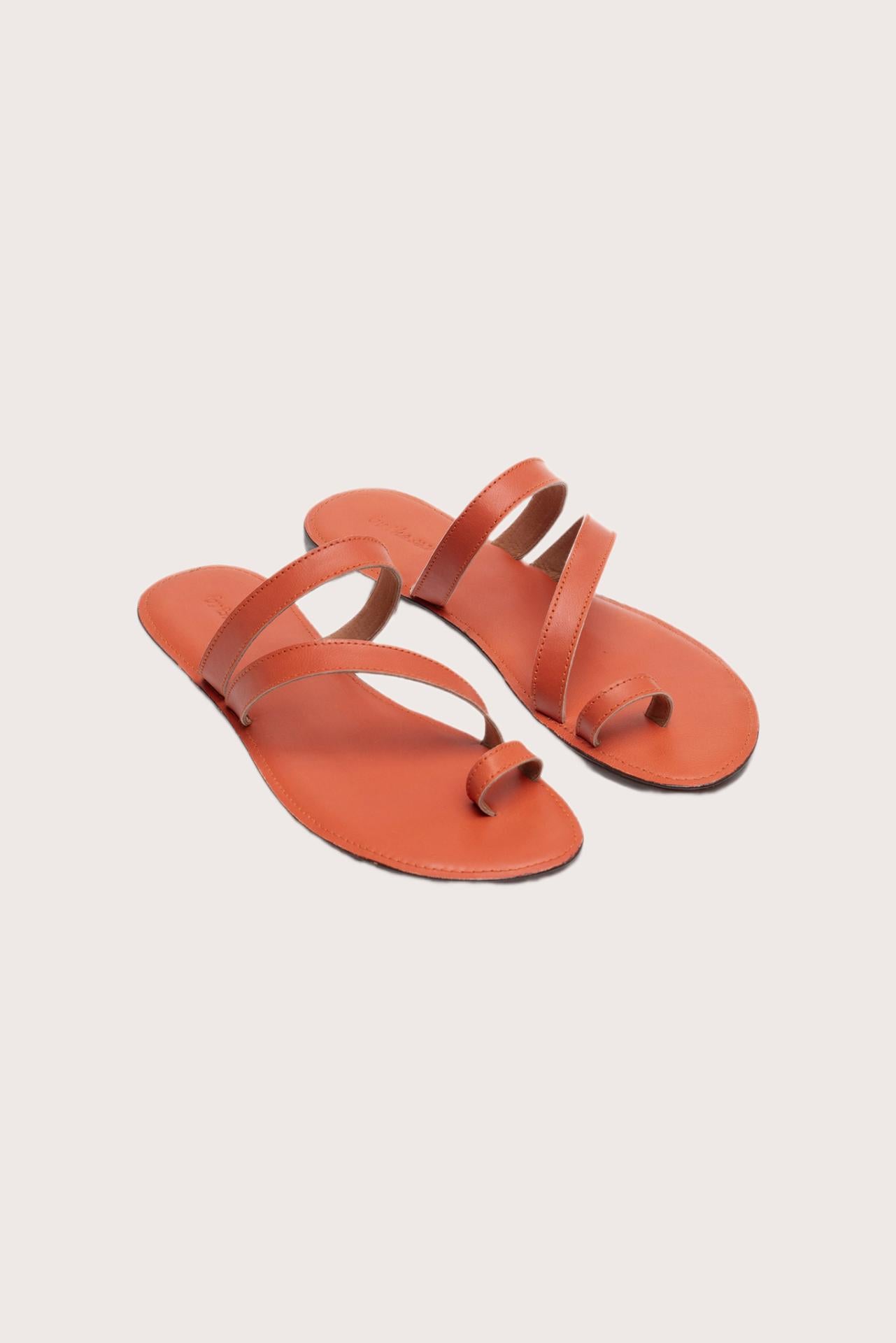 Kawula sandal in orange front view showcasing elegant straps and minimalist resort aesthetic