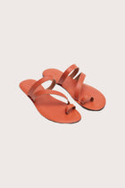Kawula sandal in orange front view showcasing elegant straps and minimalist resort aesthetic