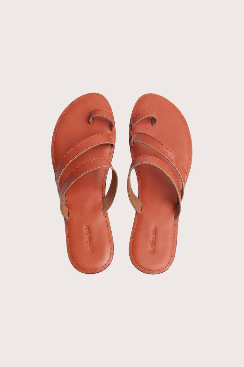 Kawula sandal in orange shown in a global view highlighting its full silhouette and refined resort design