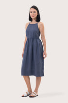 Side profile of the Kei Linen Breeze Midi Dress Indigo showing its cut and natural movement