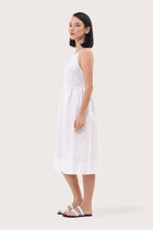 Side profile of the Kei Linen Breeze Midi Dress White showing its cut and natural movement