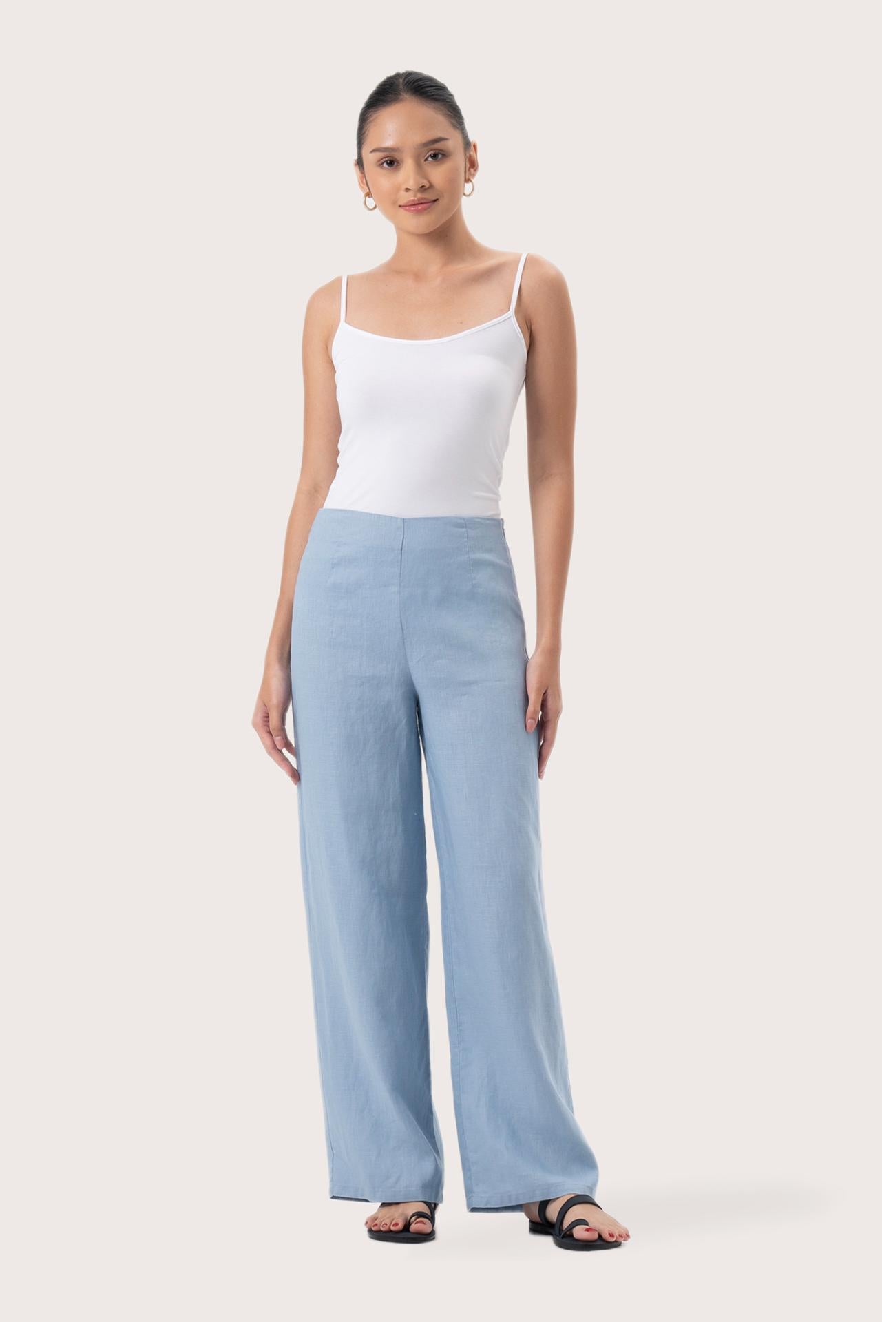 Woman wearing the Kerang Linen Pant Light Blue designed for effortless resortwear and tropical living by By The Sea Bali.