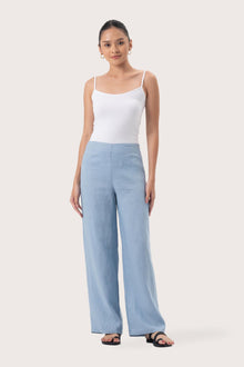 Woman wearing the Kerang Linen Pant Light Blue designed for effortless resortwear and tropical living by By The Sea Bali.