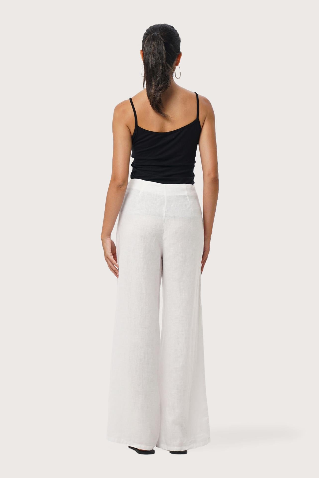 Back view of the Kerang Linen Pant Off White highlighting the garment shape and drape.