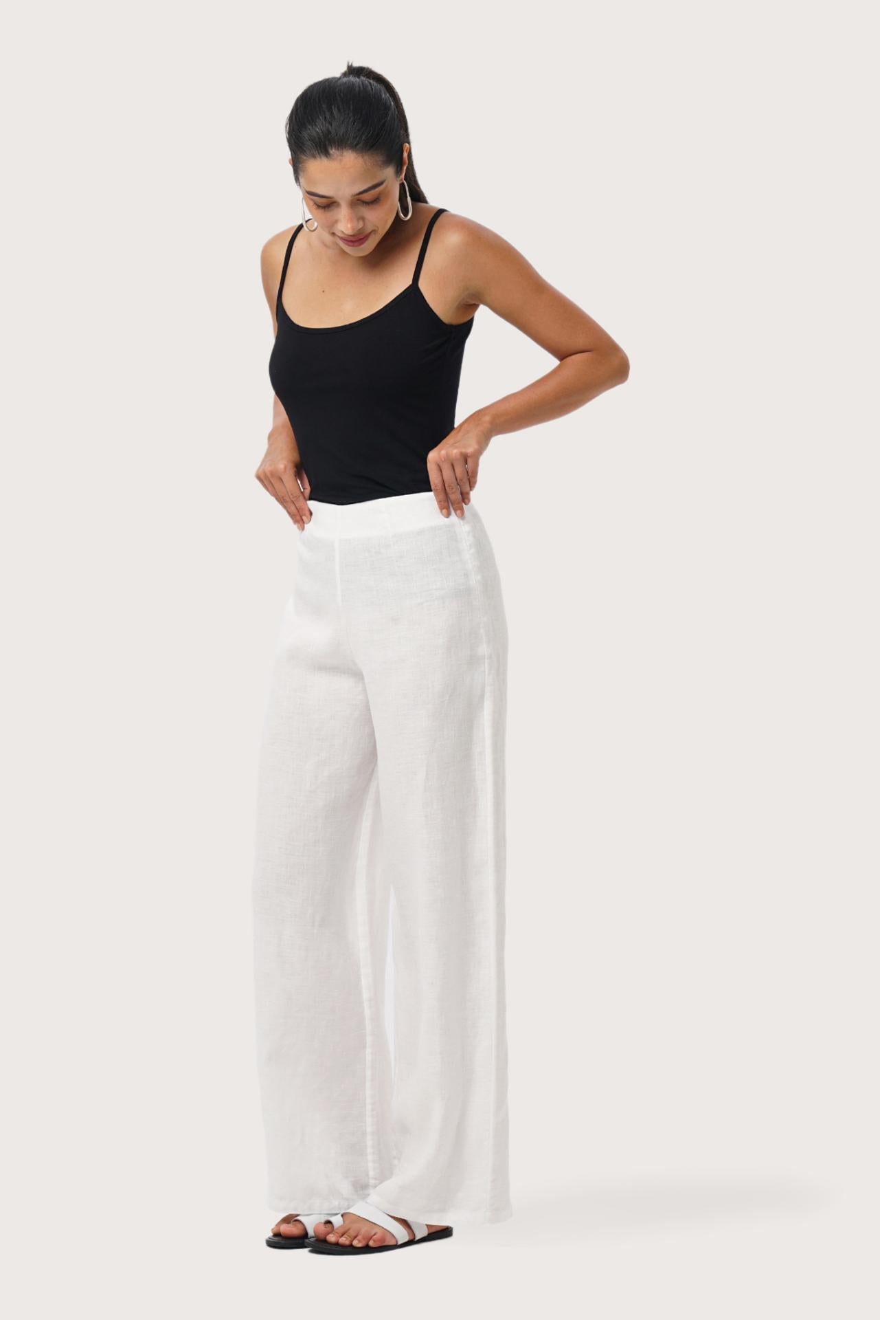 Side profile of the Kerang Linen Pant Off White showing its cut and natural movement.