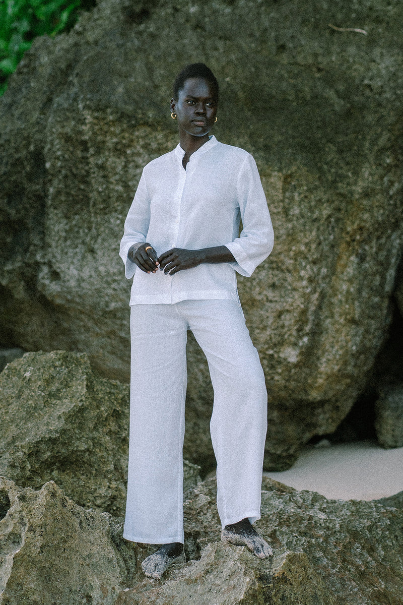 Woman wearing the Kerang Linen Pant Off White designed for effortless resortwear and tropical living by By The Sea Bali.