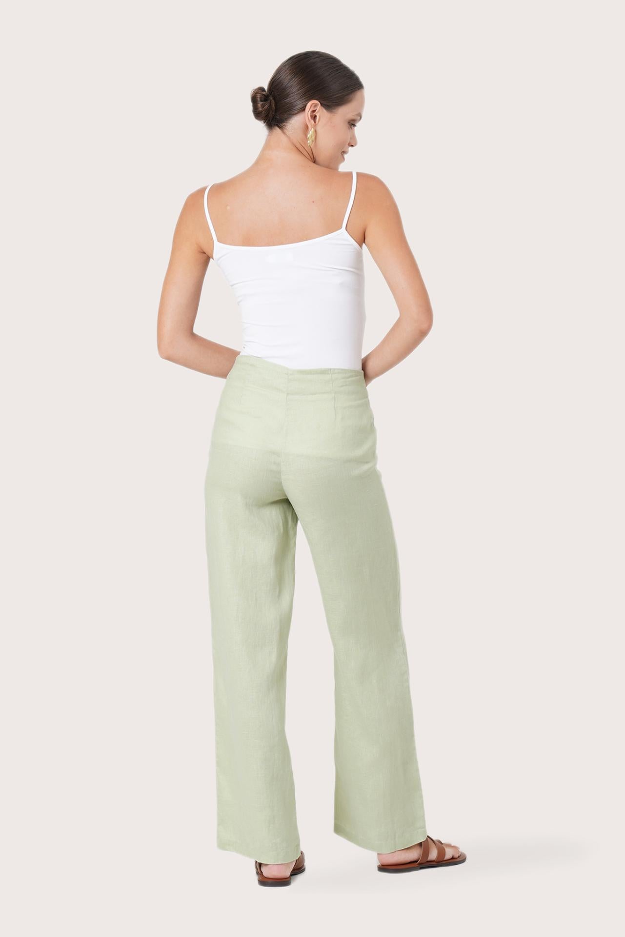 Back view of the Kerang Linen Pant Green highlighting the garment shape and drape.