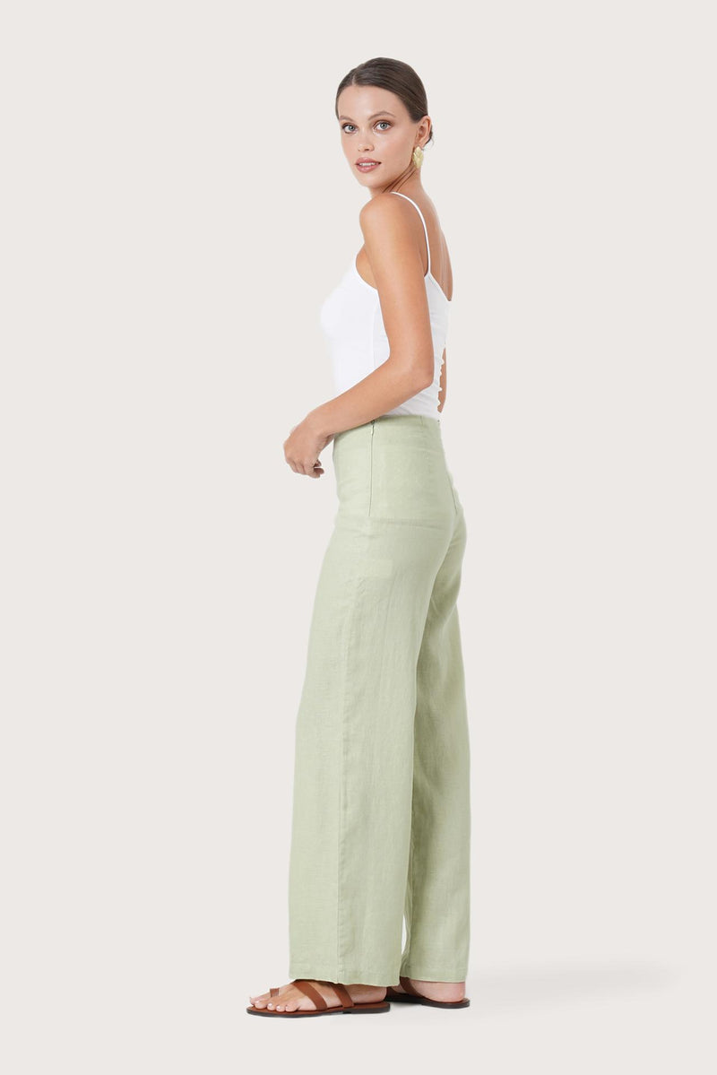 Side profile of the Kerang Linen Pant Green showing its cut and natural movement.