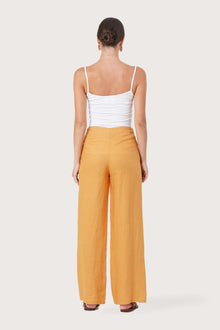 Back view of the Kerang Women's Linen Pants Orange highlighting the garment shape and drape.